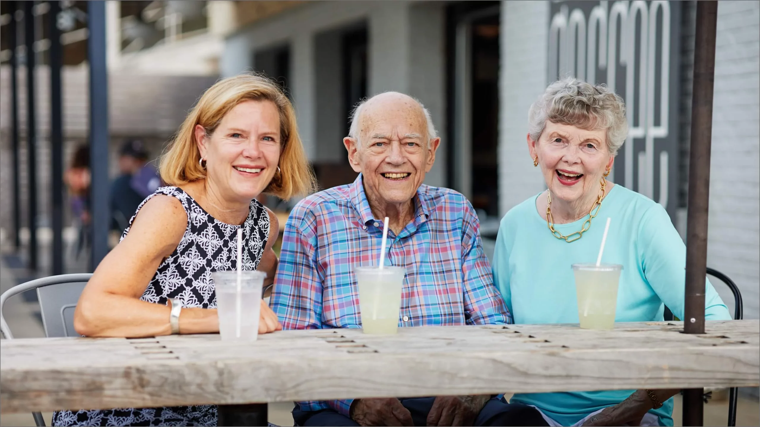 Three seniors laughing while socializing